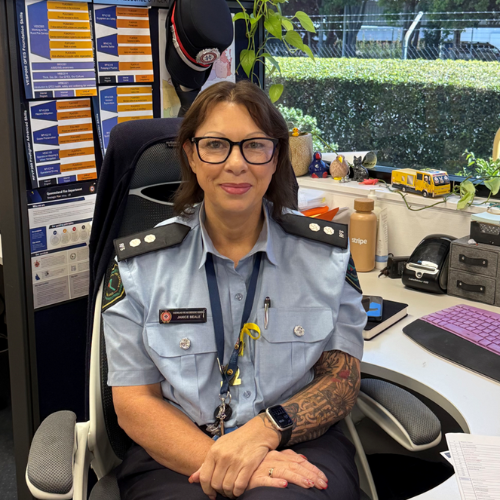 Janice in her staff uniform sitting at her desk